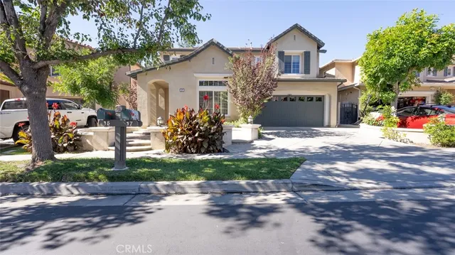a front view of a house with a yard and a garage