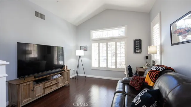 a living room with furniture fireplace and flat screen tv