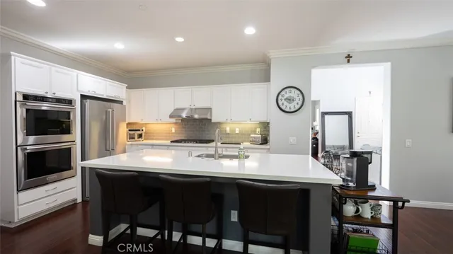 a view of a kitchen with dining table and chairs