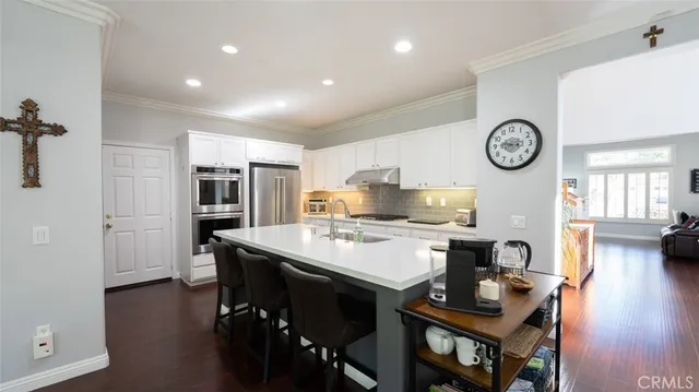 a kitchen with counter top space sink stove and cabinets
