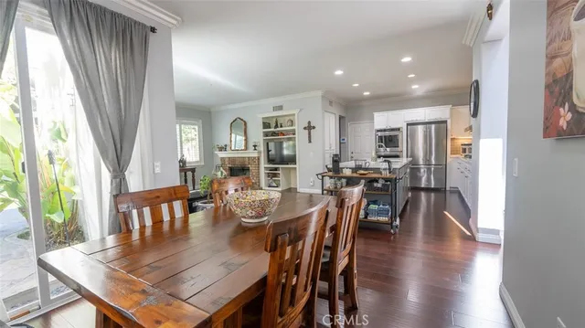 a hallway with white cabinets and wooden floor