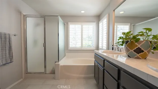 a white toilet sitting next to a bathroom sink and vanity
