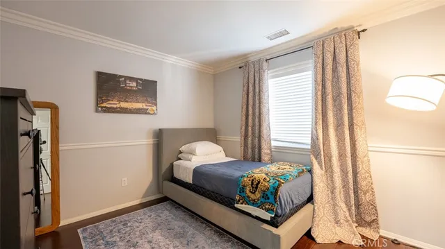 a bedroom with a bed and a large window