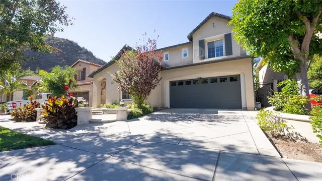 a front view of a house with a yard and a garage