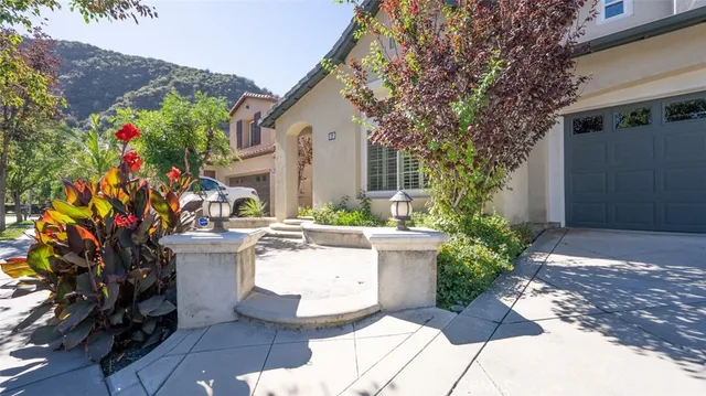 a view of a house with fountain in front of statue