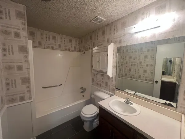 a bathroom with a sink toilet tub and shower