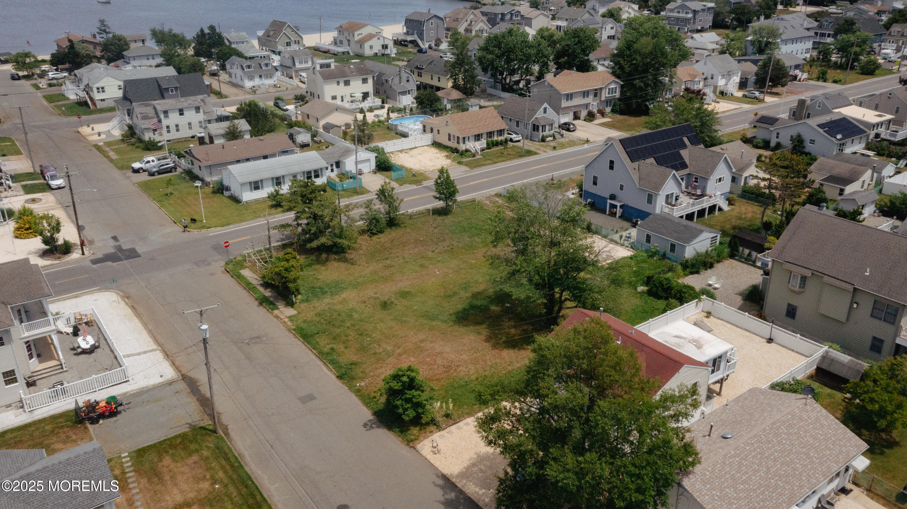 409 Newport Avenue Ocean Gate, NJ 08740 - Photo 16 of 22 an aerial view of a house with a yard and lake view
