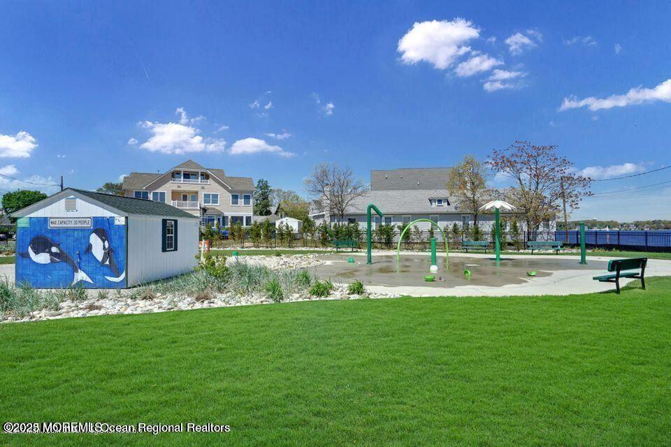 409 Newport Avenue Ocean Gate, NJ 08740 - Photo 9 of 22 a front view of a house with swimming pool and a yard