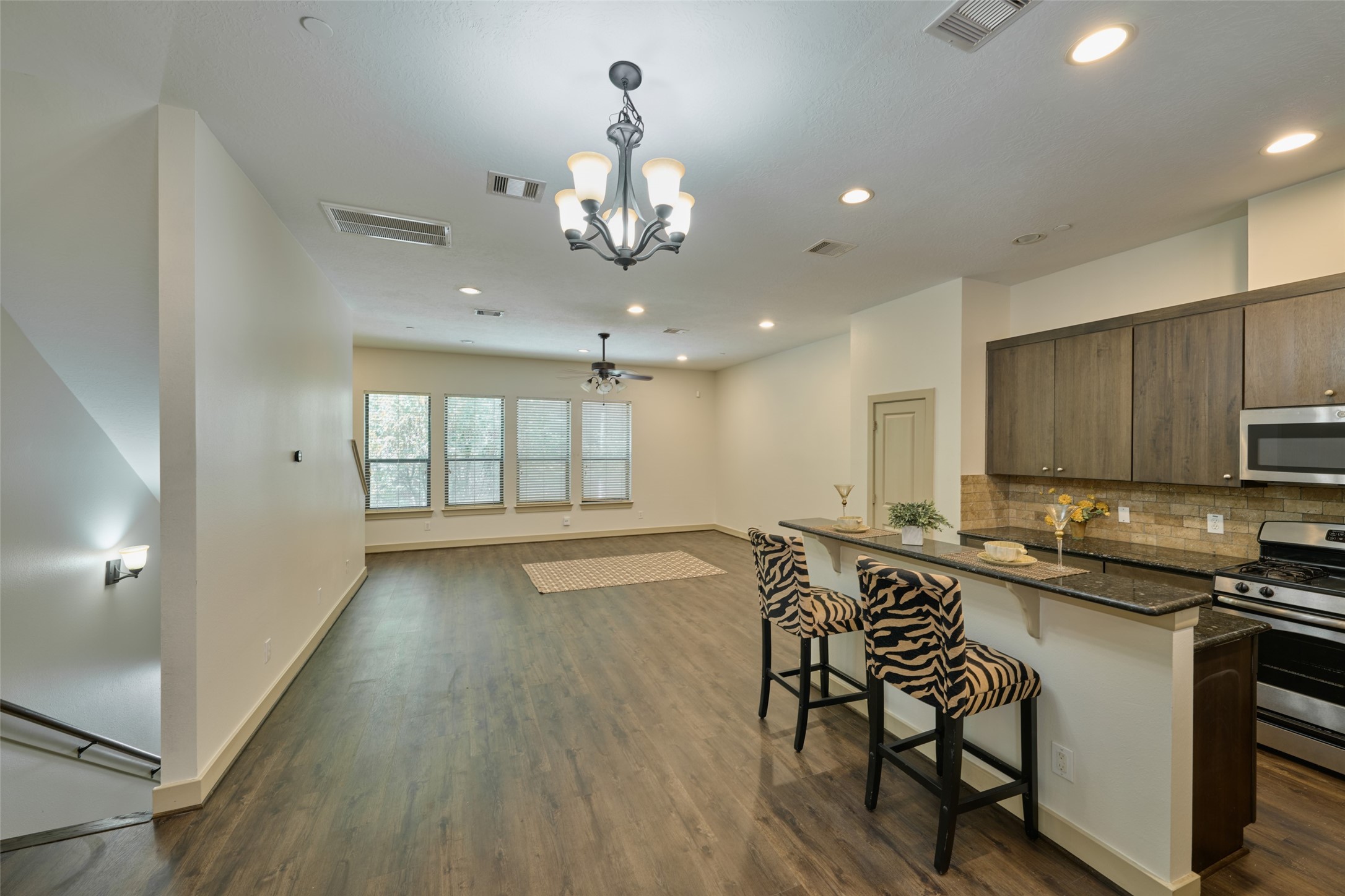 2422 Navigation Boulevard, Unit E Houston, TX 77003 - Photo 8 of 29 a view of a kitchen with kitchen island granite countertop wooden floor and stainless steel appliances