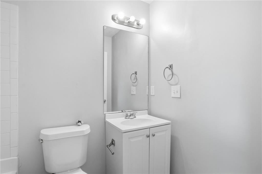 5855 Crescent Ridge Court Lithonia, GA 30058 - Photo 33 of 46 a bathroom with a sink a toilet and mirror