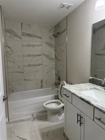 a bathroom with a sink a toilet and a bathtub