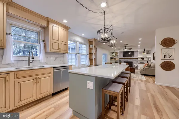 a kitchen with living room and sink