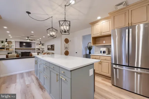 a kitchen with stainless steel appliances granite countertop a sink refrigerator and cabinets