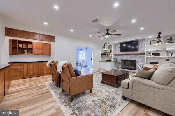 a living room with furniture a fireplace and a flat screen tv
