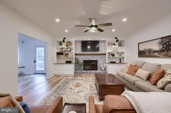 a living room with furniture and wooden floor