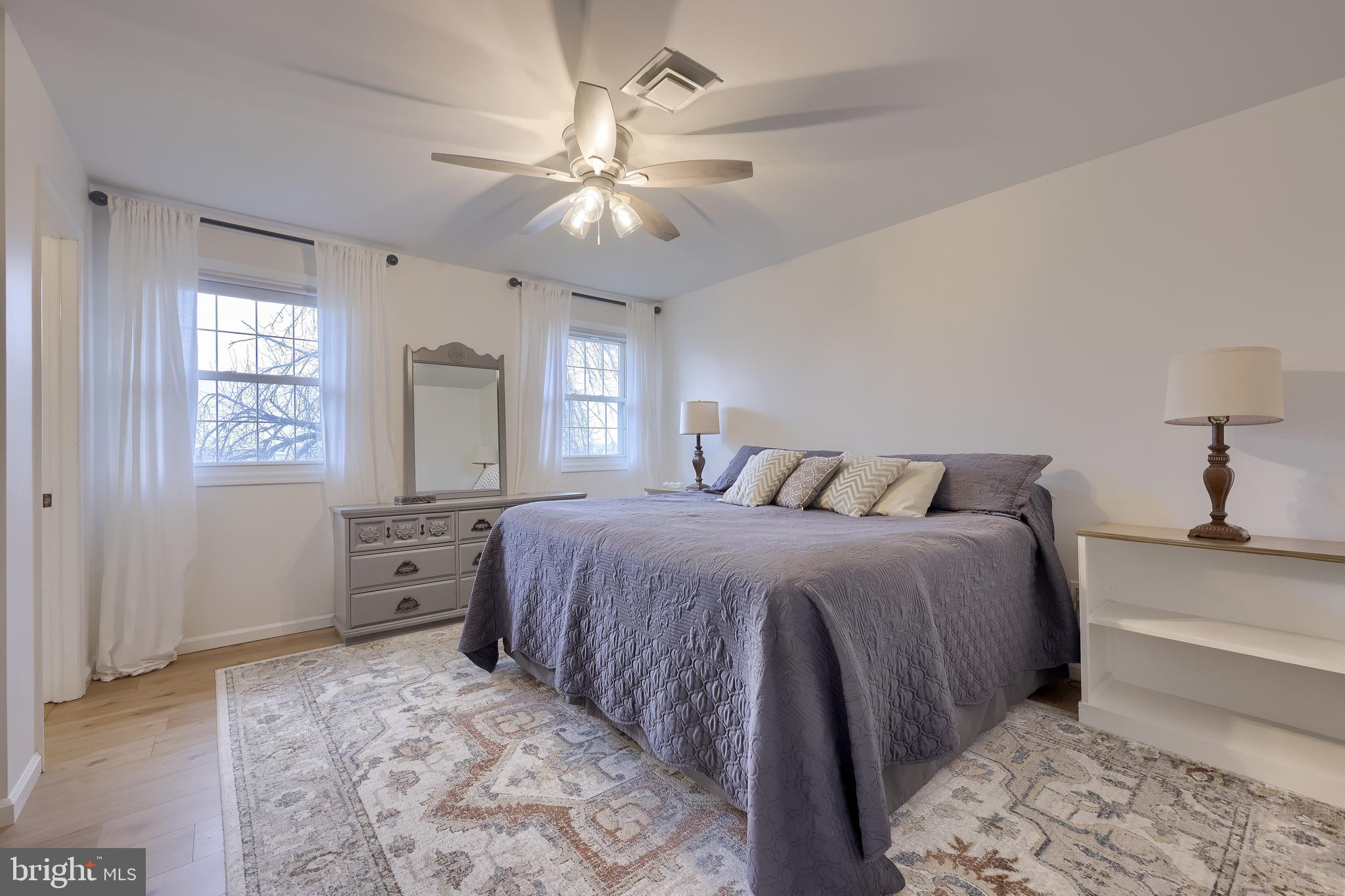 701 Colony Drive Palmyra, PA 17078 - Photo 38 of 51 a spacious bedroom with a bed and a chandelier