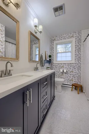 a bedroom with a bed window and a chandelier