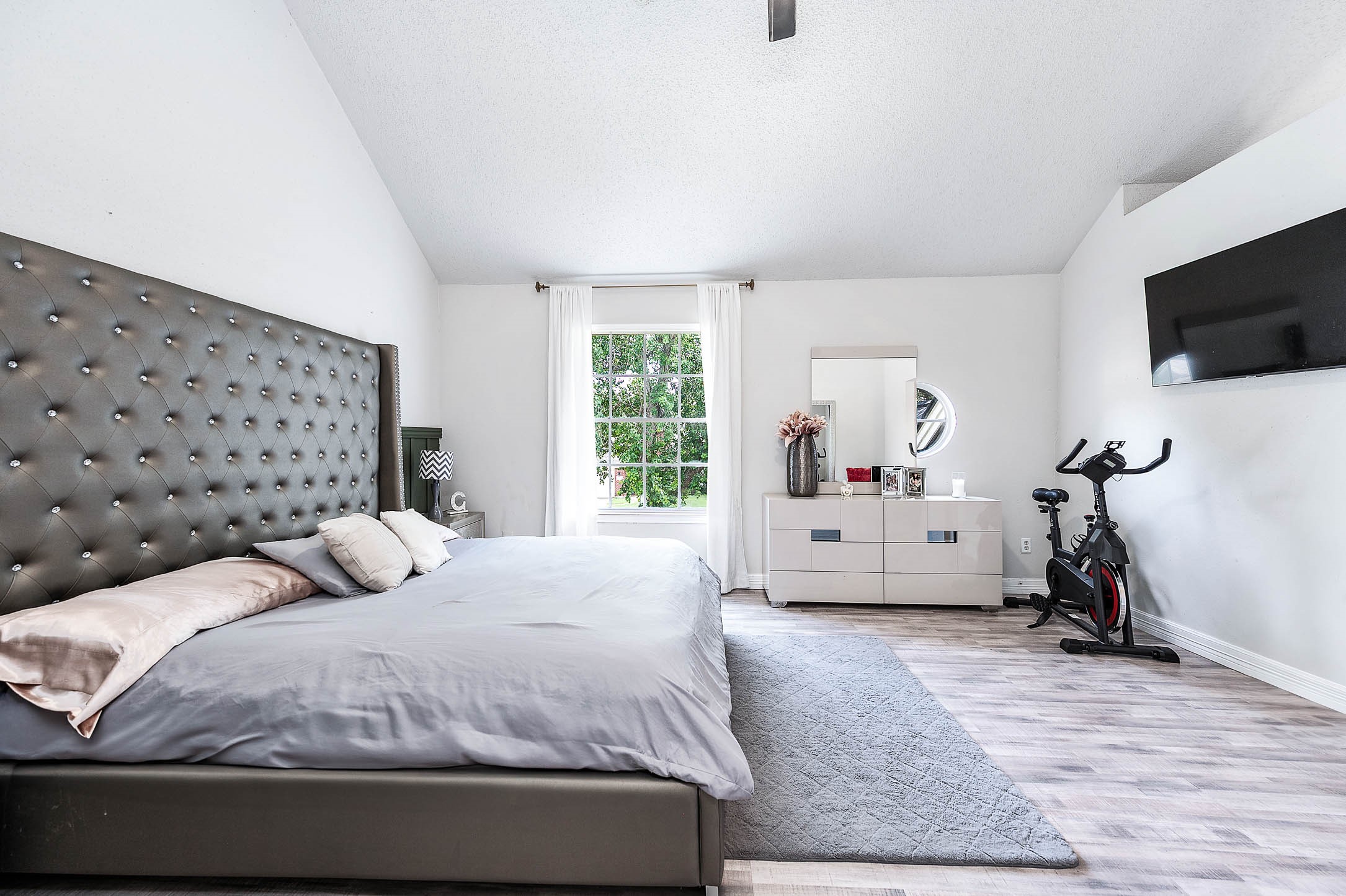 18446 North Willow Bluff Road Katy, TX 77449 - Photo 23 of 31 a bedroom with a bed and a flat screen tv