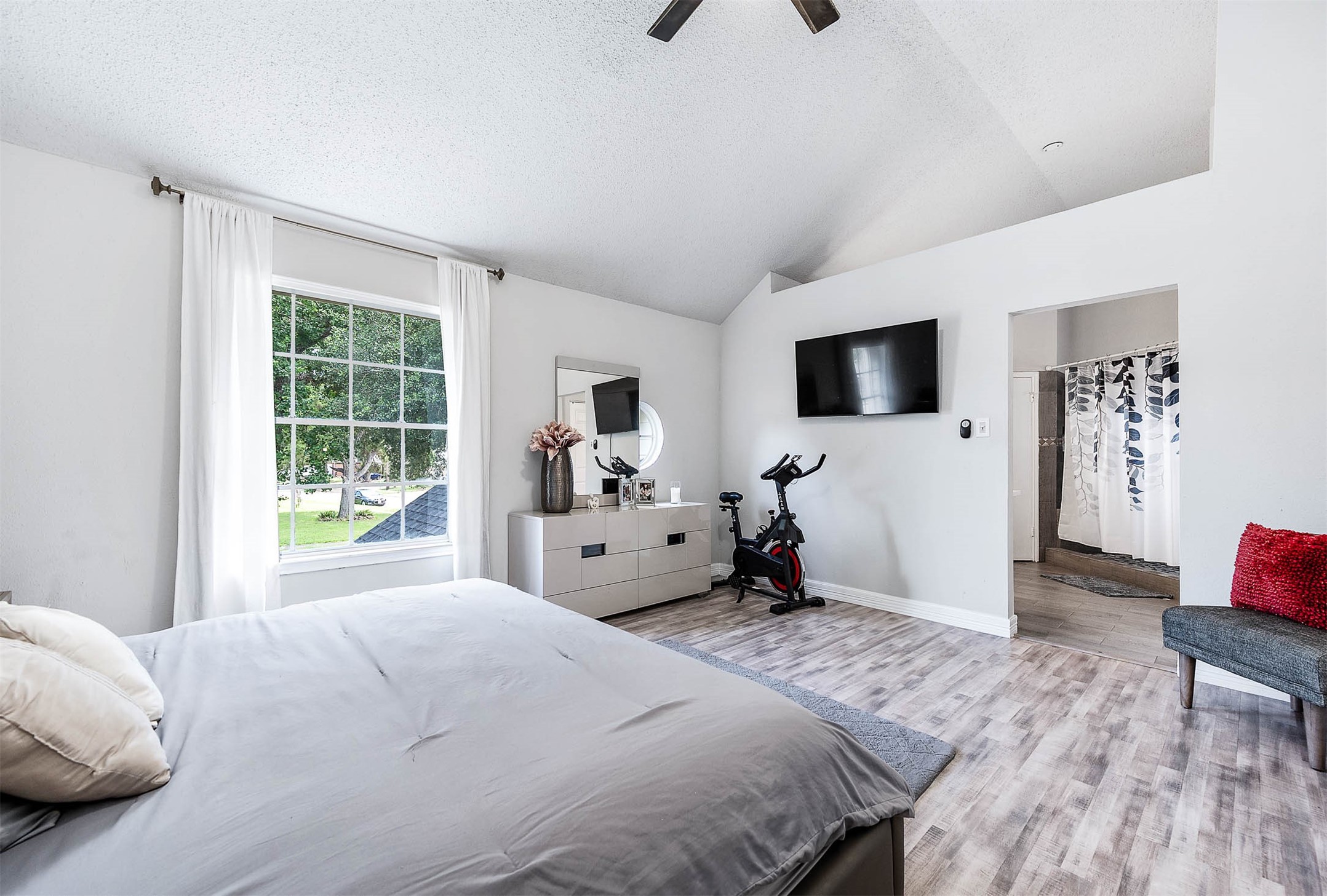 18446 North Willow Bluff Road Katy, TX 77449 - Photo 24 of 31 a bedroom with a bed a flat screen tv and a couch