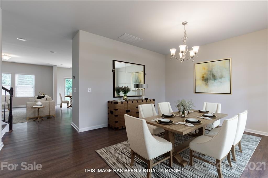 1556 Spring Blossom Trail Fort Mill, SC 29708 - Photo 2 of 22 a view of a dining room with furniture and wooden floor