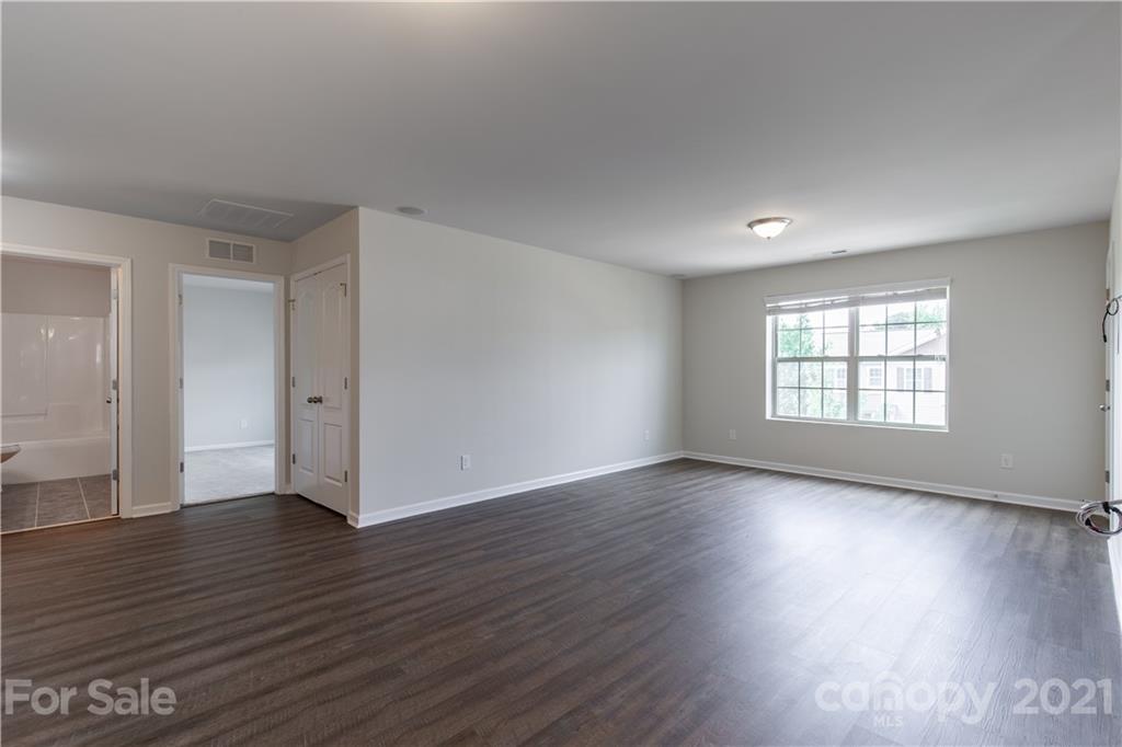 1556 Spring Blossom Trail Fort Mill, SC 29708 - Photo 12 of 22 an empty room with wooden floor and windows