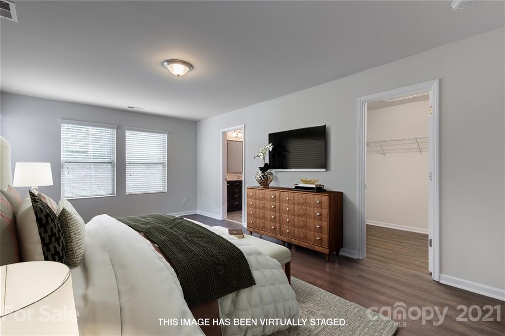 1556 Spring Blossom Trail Fort Mill, SC 29708 - Photo 13 of 22 a bedroom with a bed and a flat screen tv