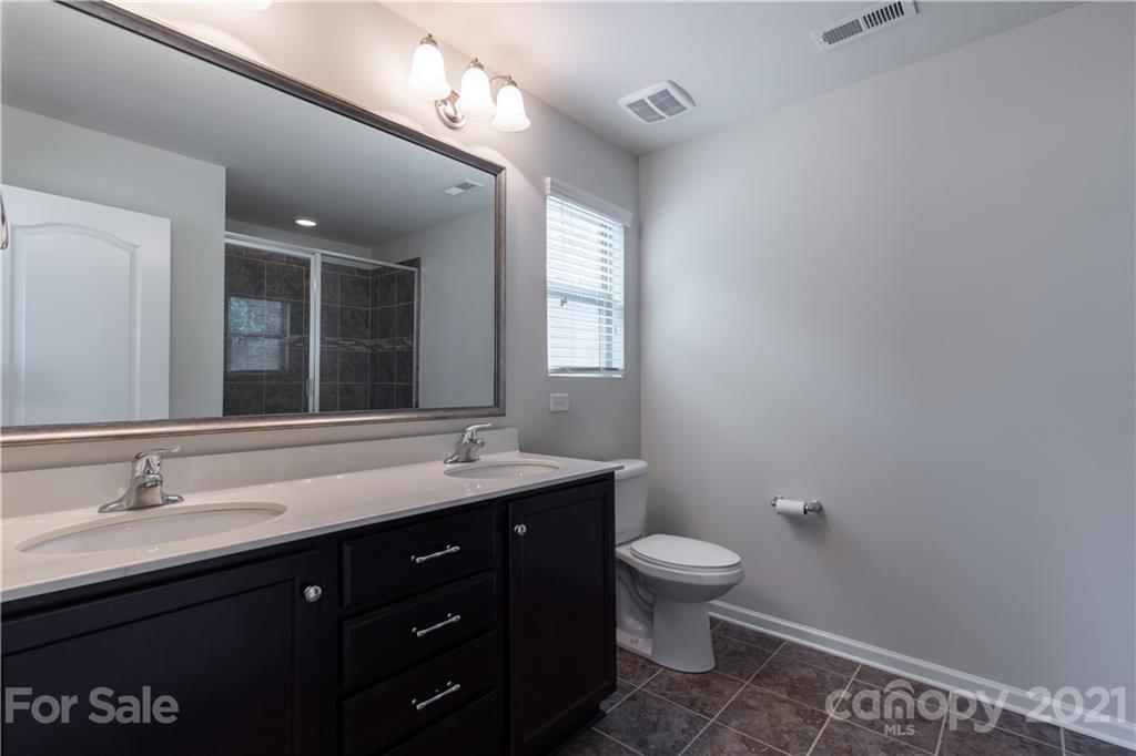 1556 Spring Blossom Trail Fort Mill, SC 29708 - Photo 15 of 22 a bathroom with a granite countertop sink a toilet and a mirror