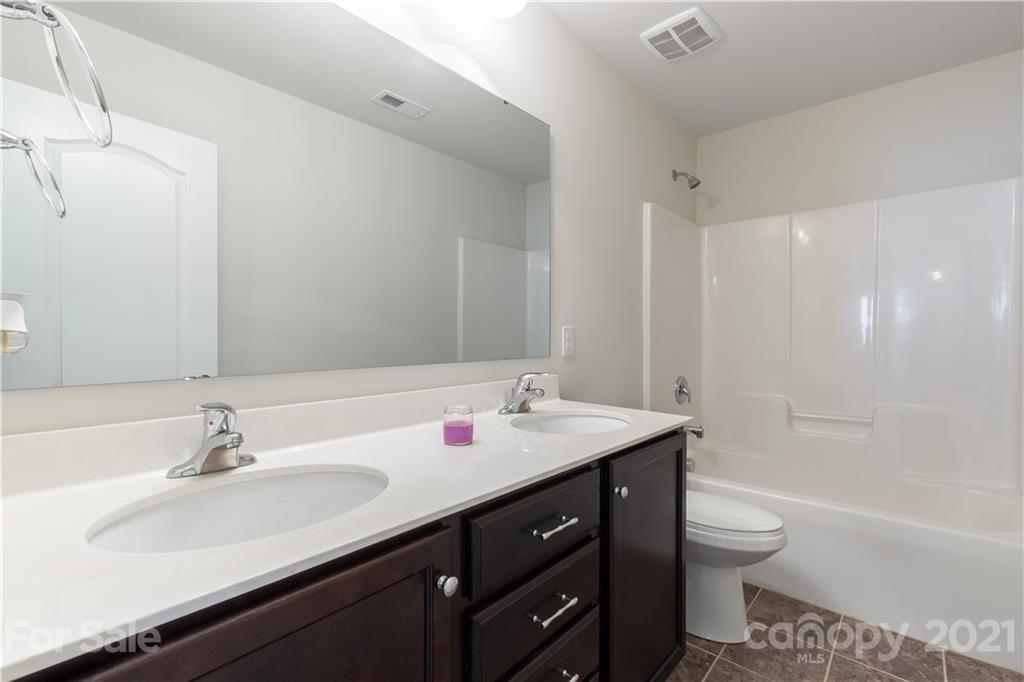 1556 Spring Blossom Trail Fort Mill, SC 29708 - Photo 18 of 22 a bathroom with a sink a toilet and shower