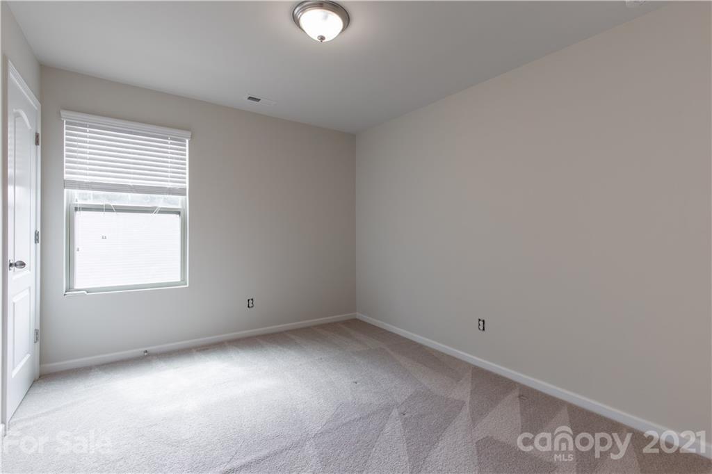1556 Spring Blossom Trail Fort Mill, SC 29708 - Photo 19 of 22 an empty room with a window