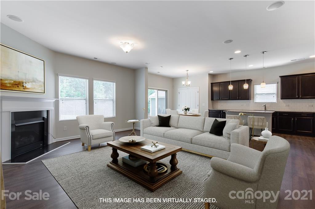 1556 Spring Blossom Trail Fort Mill, SC 29708 - Photo 4 of 22 a living room with furniture a fireplace and a flat screen tv