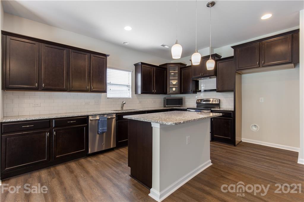 1556 Spring Blossom Trail Fort Mill, SC 29708 - Photo 6 of 22 a kitchen with stainless steel appliances granite countertop a stove a sink and a refrigerator