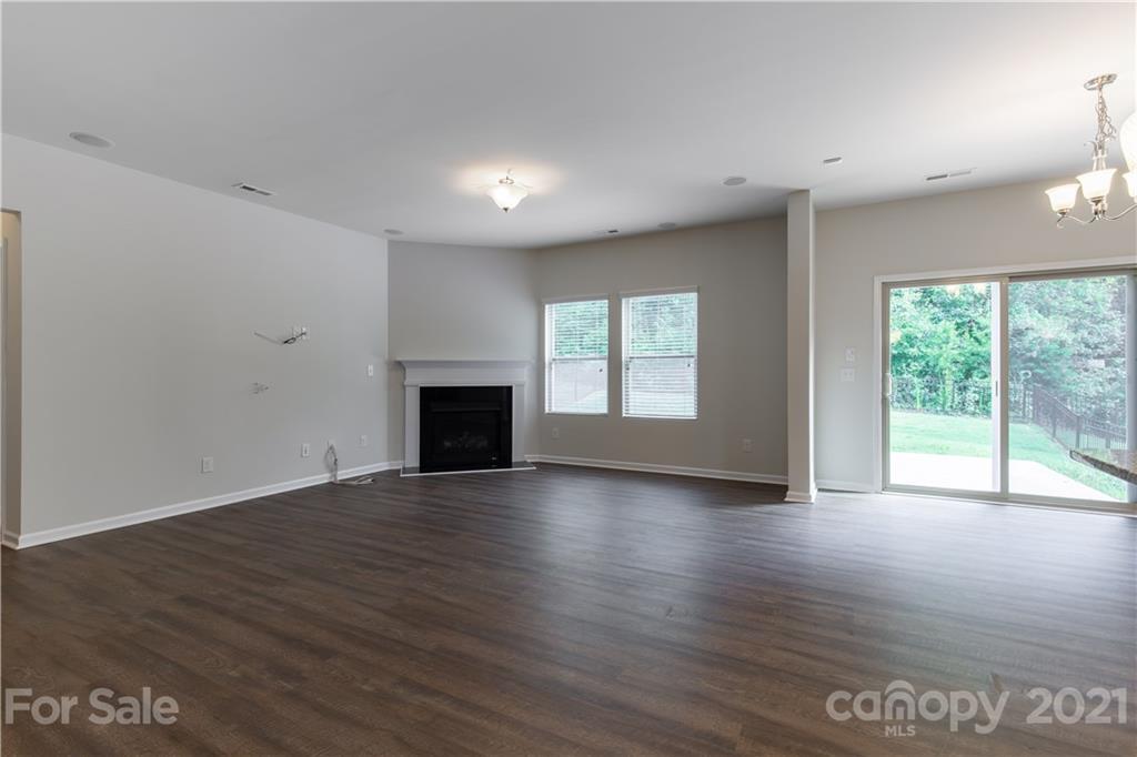 1556 Spring Blossom Trail Fort Mill, SC 29708 - Photo 8 of 22 a view of an empty room with wooden floor and a window