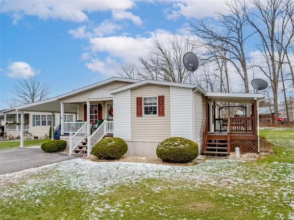 a view of a chair and tables in the back yard of the house