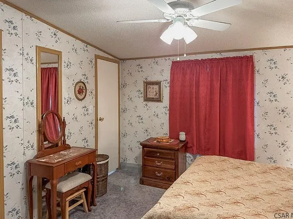 a bedroom with a bed and a dresser in it