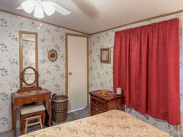 wooden room with a bed and a dresser