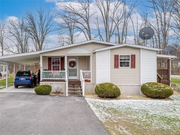 a view of a house with backyard and a garage