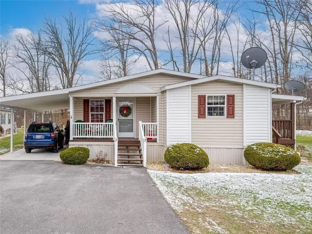 a view of a house with backyard and a garage