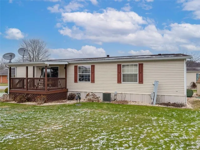 a view of a house with a yard and sitting area