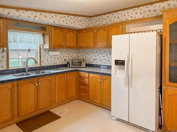 a kitchen with stainless steel appliances a refrigerator and a sink
