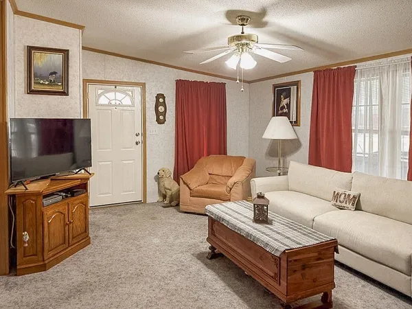 a living room with furniture and a chandelier