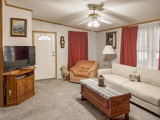 a living room with furniture and a chandelier