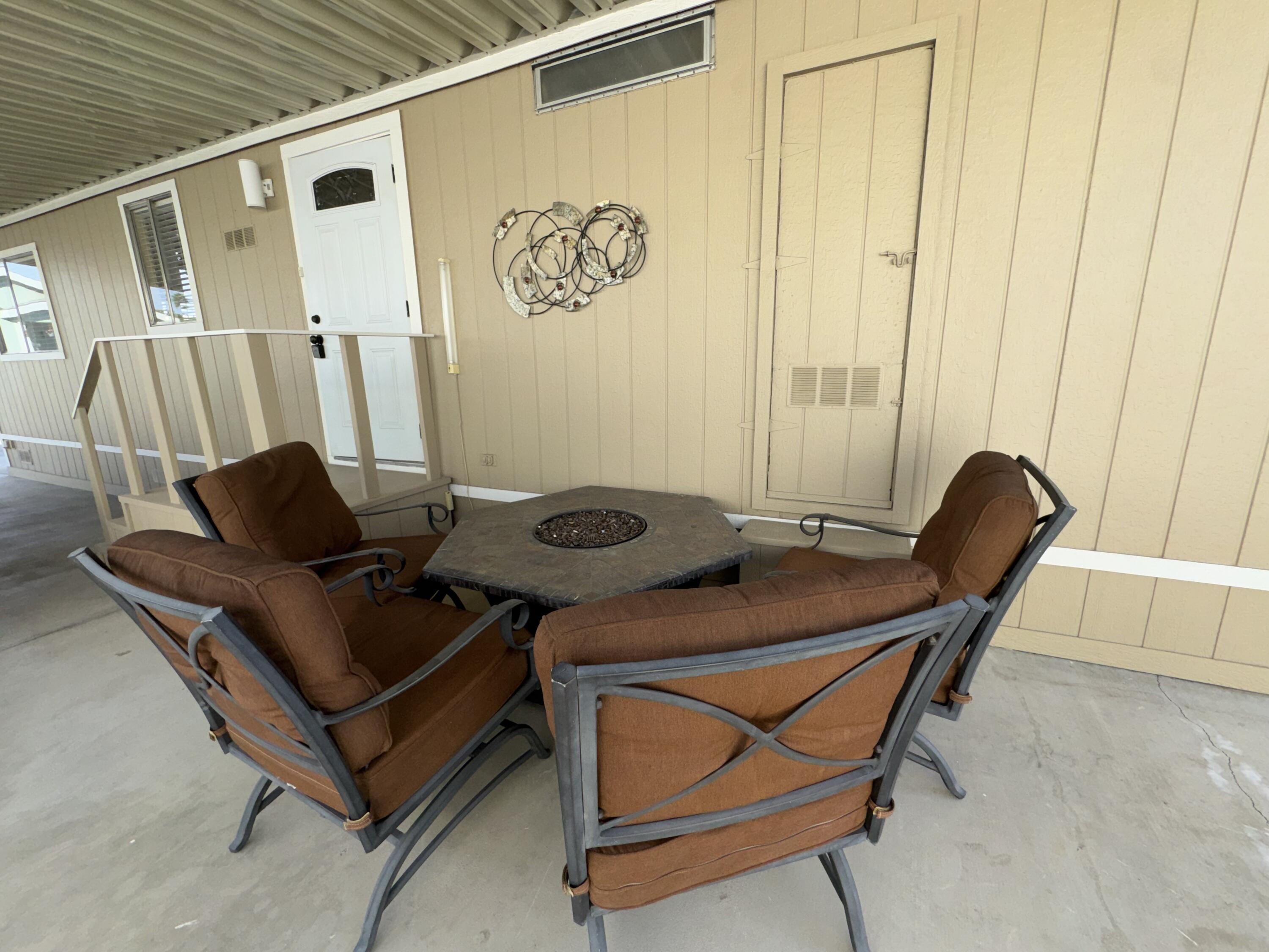 46618 Madison Street, Unit 153 Indio, CA 92201 - Photo 19 of 47 a table and chairs in a patio