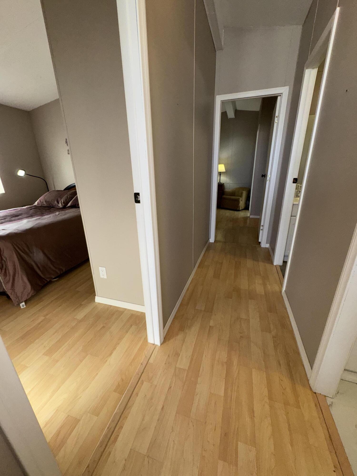 46618 Madison Street, Unit 153 Indio, CA 92201 - Photo 33 of 47 a view of a hallway with wooden floor and staircase