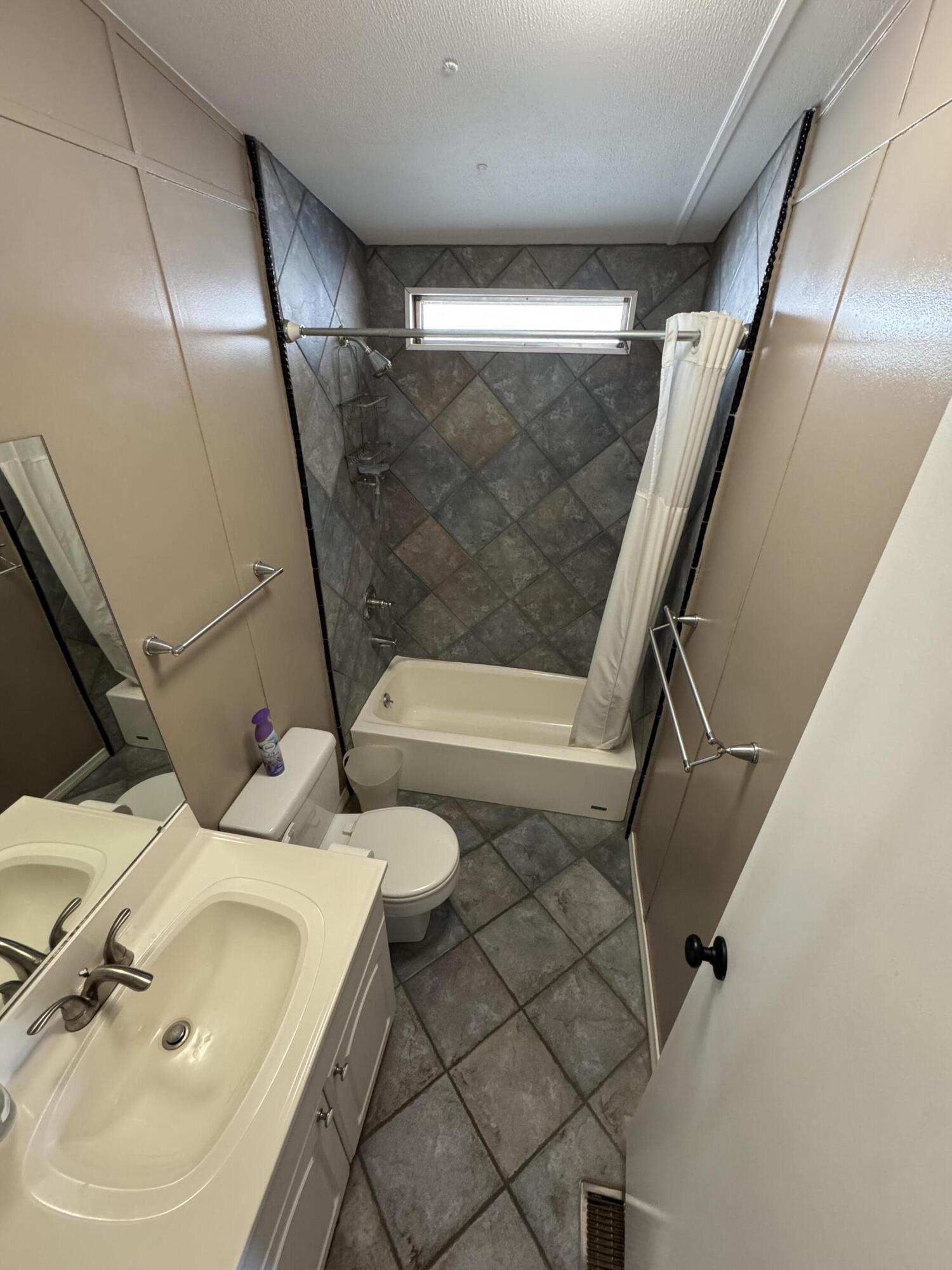 46618 Madison Street, Unit 153 Indio, CA 92201 - Photo 36 of 47 a bathroom with a sink and mirror with toilet