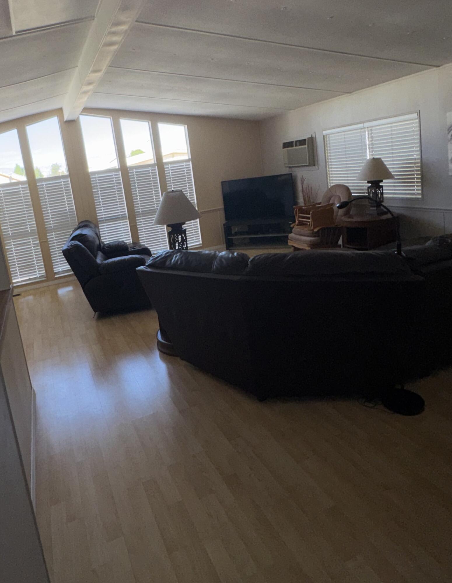 46618 Madison Street, Unit 153 Indio, CA 92201 - Photo 4 of 14 a living room with furniture and a fireplace