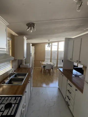 a kitchen with sink stove and cabinets