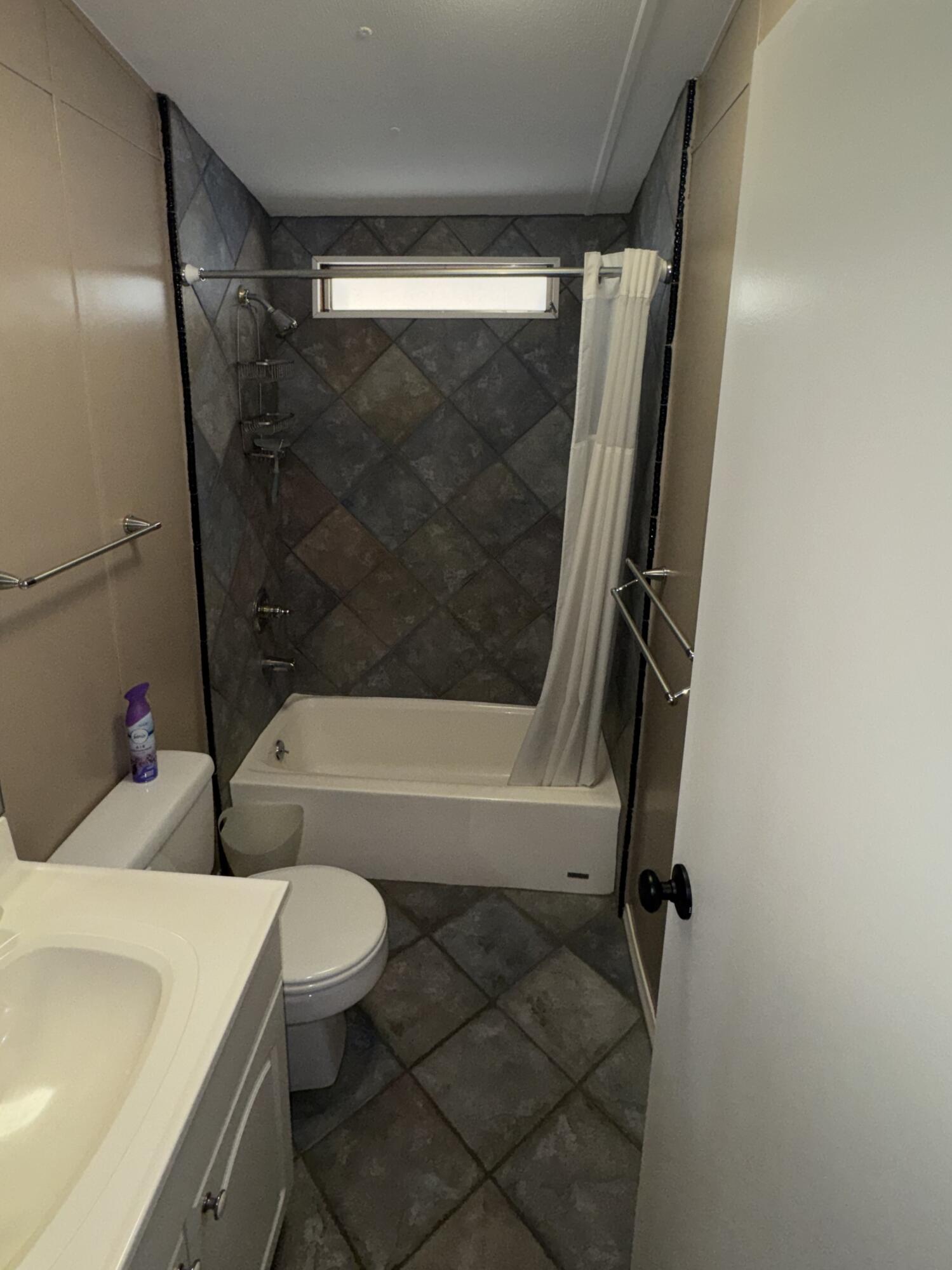 46618 Madison Street, Unit 153 Indio, CA 92201 - Photo 9 of 14 a bathroom with a bathtub shower sink vanity and toilet