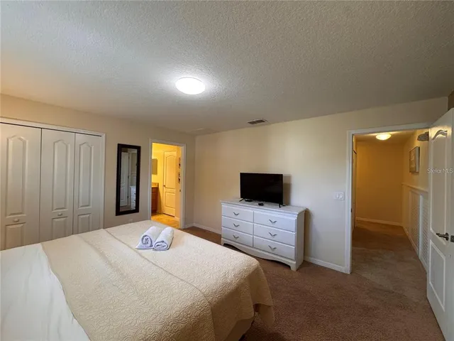 a bathroom with a granite countertop sink a large mirror and a bathtub