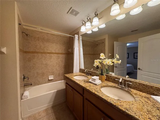 a bedroom with a bed and a television