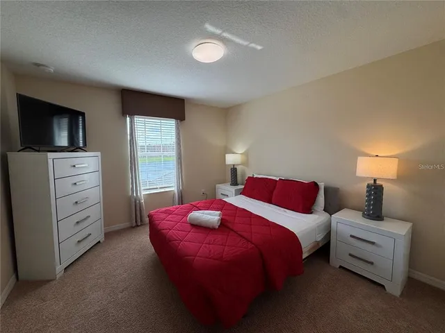 a bedroom with two beds and a chandelier